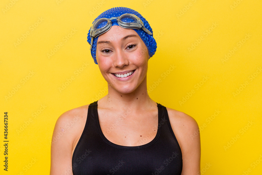 Young australian swimmer woman isolated on yellow background Young australian swimmer woman isolated on yellow background