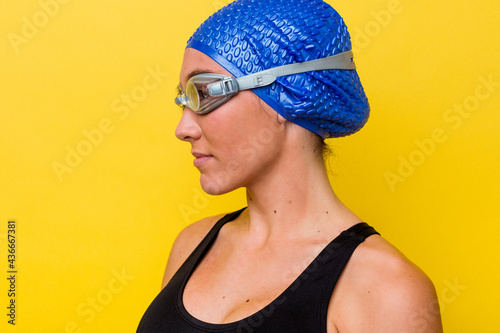 Young australian swimmer woman isolated on yellow background