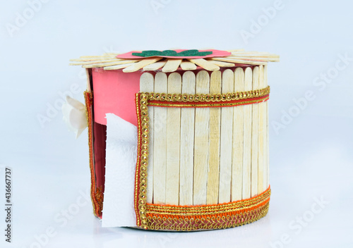 A nice tissue box made with some small wooden ice cream sticks stacked together