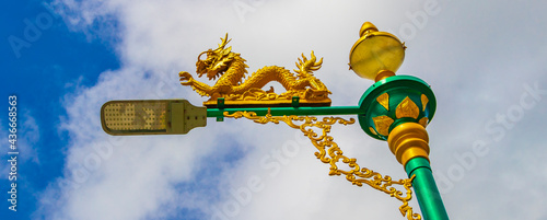 Artistic turquoise green street lantern with golden dragon Phuket Thailand. photo