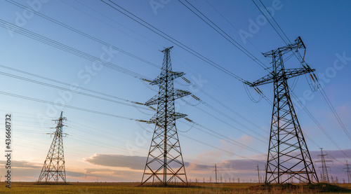 Canvastavla silhouette of high voltage power lines against a colorful sky at sunrise