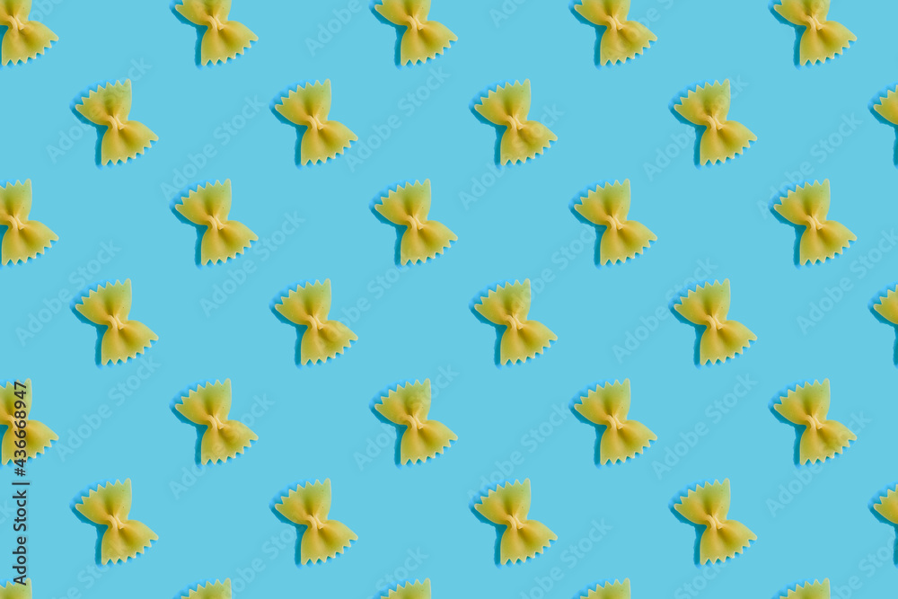 Colorful pattern of pasta farfalle on a blue background Colorful pattern of pasta farfalle on a blue background