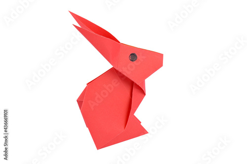 A pink little rabbit made with small craft paper and nicely placed on a paper background