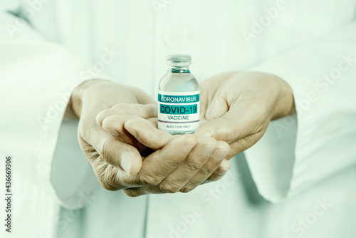 doctor with a simulated bottle of covid-19 vaccine
