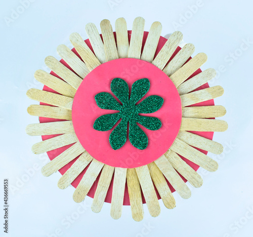 A round decorative design made with many small sticks stacked all together