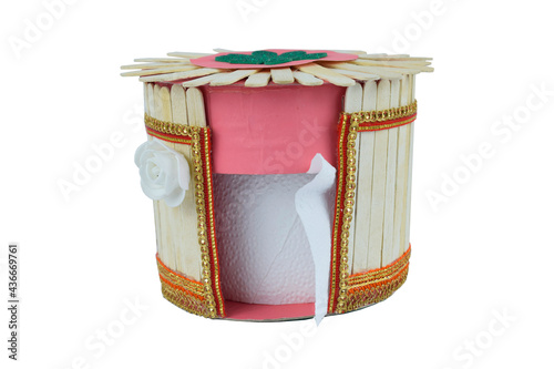 A tissue box made with some small wooden ice cream sticks stacked together