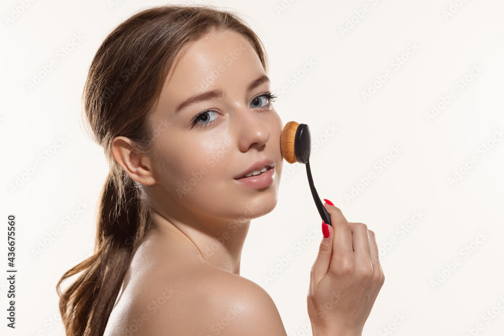 Portrait of young female fashion model isolated on white studio background. Beautiful caucasian woman with well-kept skin.