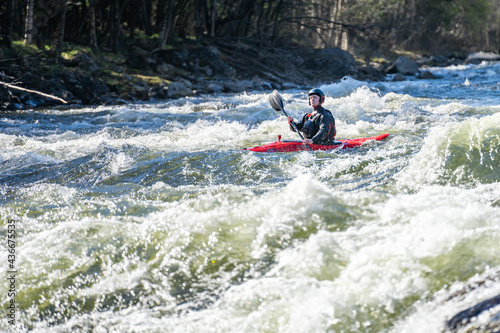 Extreme kayaker in the middle of rapid