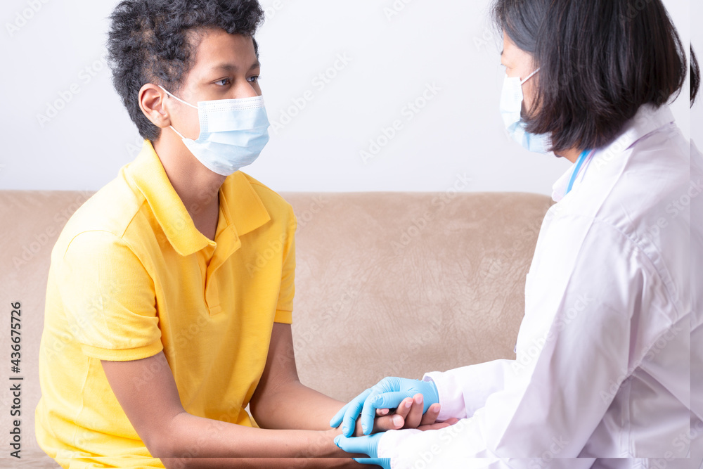 Medical care, Woman doctor wearing facemask taking care patient, Male doctor comfort the young boy patient, Business medical health care, Female wearing protection mask take care teenager man patient. Medical care, Woman doctor wearing facemask taking care patient, Male doctor comfort the young boy patient, Business medical health care, Female wearing protection mask take care teenager man patient.