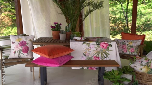 Table set with floral print tablecloth, with flowers on the table