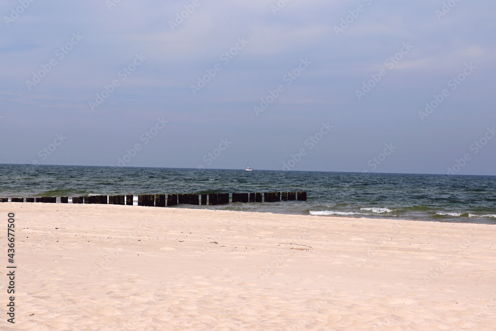 Warm sea sand on the Baltic Sea beach, Dziwnów, Poland Warm sea sand on the Baltic Sea beach, Dziwnów, Poland
