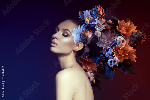 Beauty flowers face of a woman with double exposure. Portrait of a girl neon light and color, professional makeup, nude back of a woman, flowers in the head photo