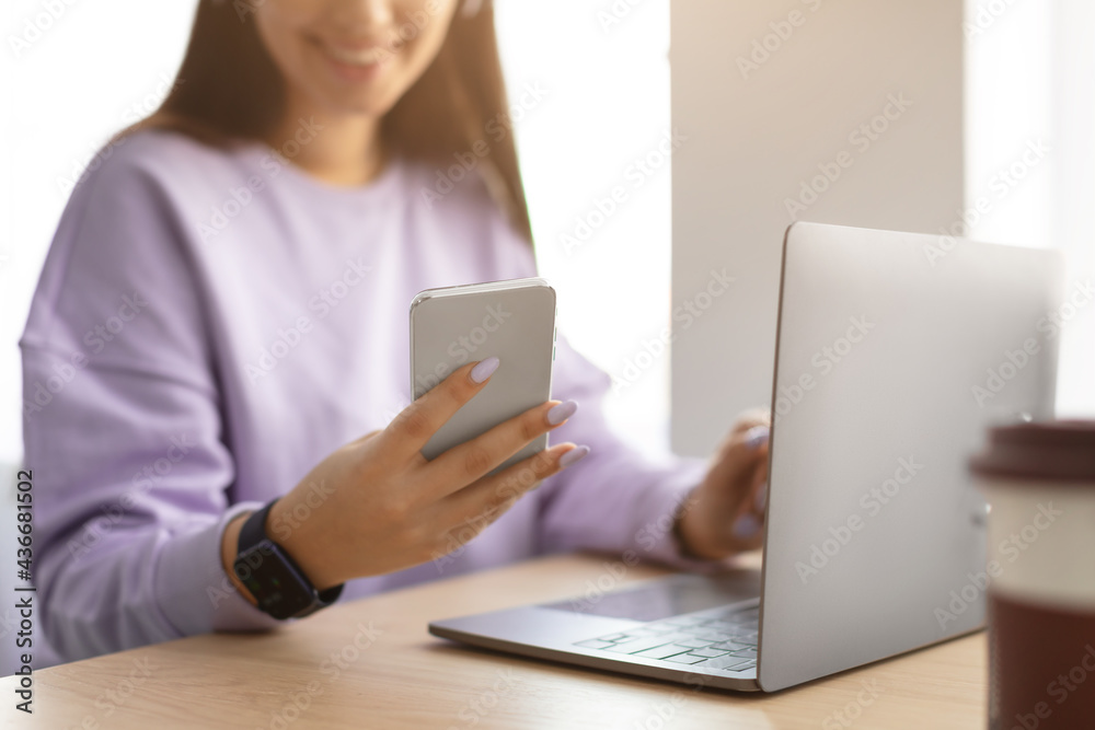 Happy woman sitting at desk reading text message Happy woman sitting at desk reading text message