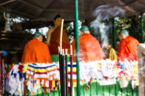 Agarbatti translates to incense sticks against out of focus Idols of Buddha and disciples under Sacred Bodhi Tree   complex at Sarnath  where Lord Buddha delivered first sermon