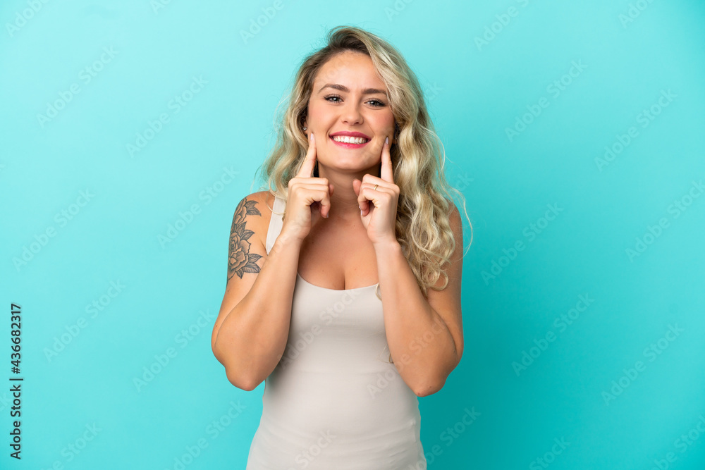 Young Brazilian woman isolated on blue background smiling with a happy and pleasant expression Young Brazilian woman isolated on blue background smiling with a happy and pleasant expression