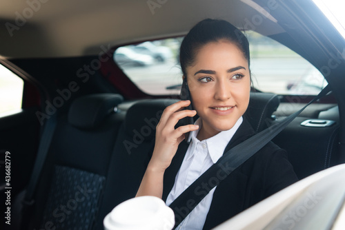 Businesswoman talking on phone in car. © Mego-studio