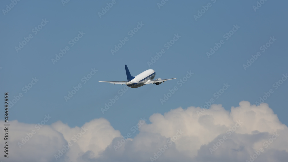 Passenger plane flying in cloudy sky Passenger plane flying in cloudy sky