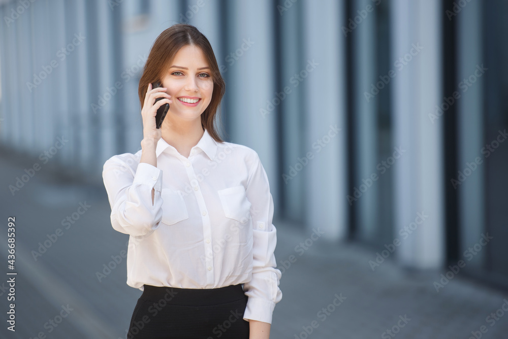 Beautiful woman talking on a mobile phone in the city center Beautiful woman talking on a mobile phone in the city center