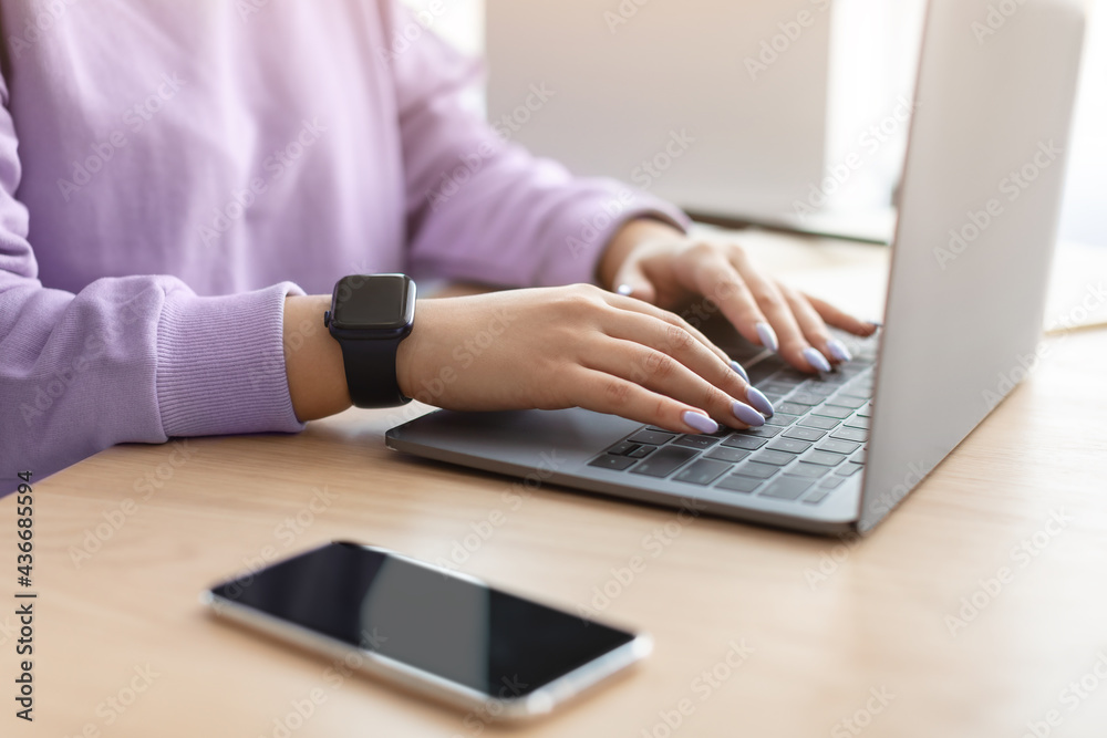 Happy woman sitting at desk reading text message Happy woman sitting at desk reading text message
