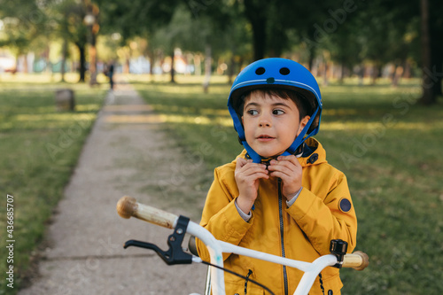 cute little boy preparing to ride a bike