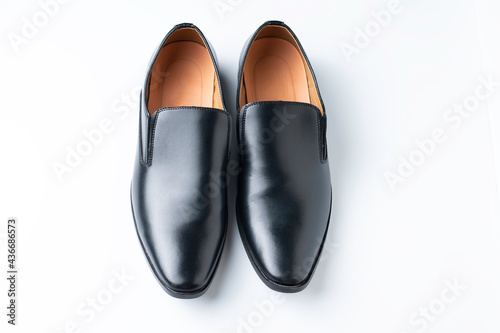 A pair of black loafer shoes isolated