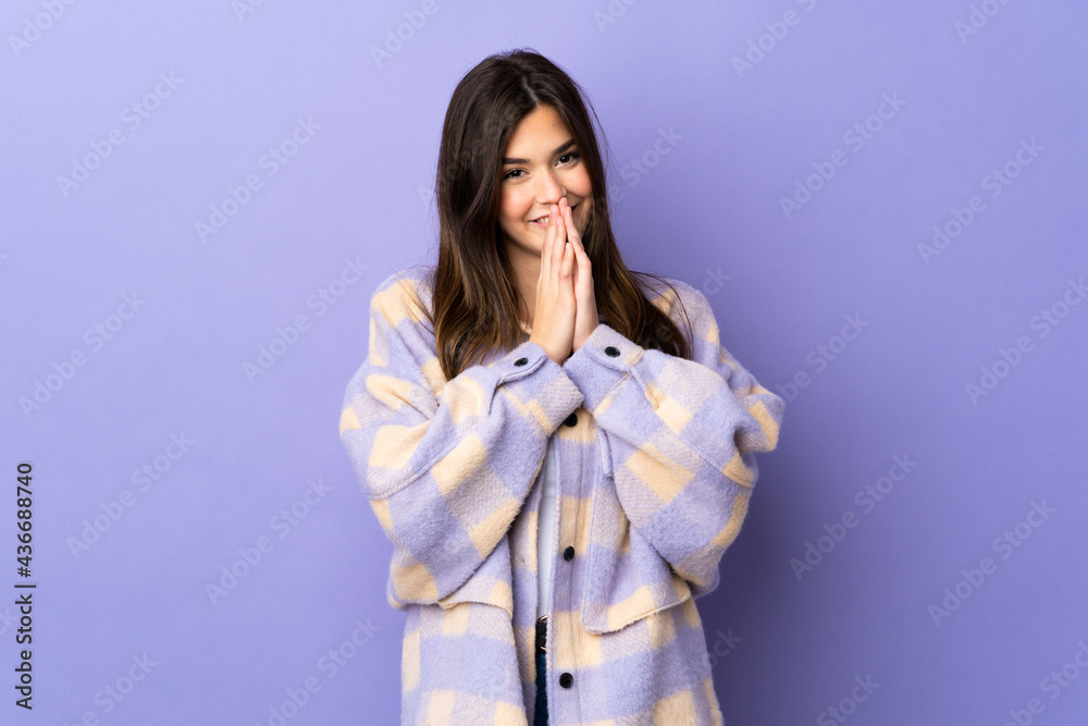 Teenager Brazilian girl over isolated purple background keeps palm together. Person asks for something Teenager Brazilian girl over isolated purple background keeps palm together. Person asks for something