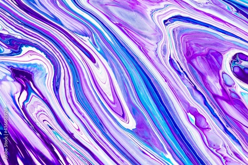 Fluid art texture. Abstract backdrop with mixing paint effect. Liquid acrylic picture with chaotic mixed paints. Can be used for posters or wallpapers. Purple, blue and white overflowing colors.