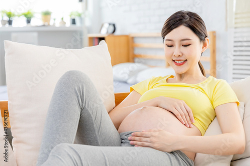 pregnant woman touch her belly