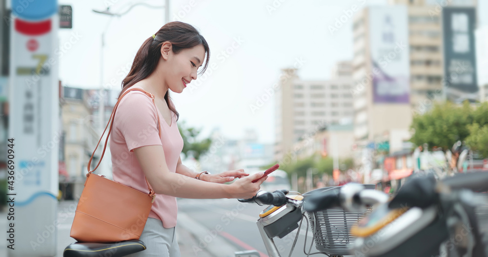 woman rent bicycle from sharing