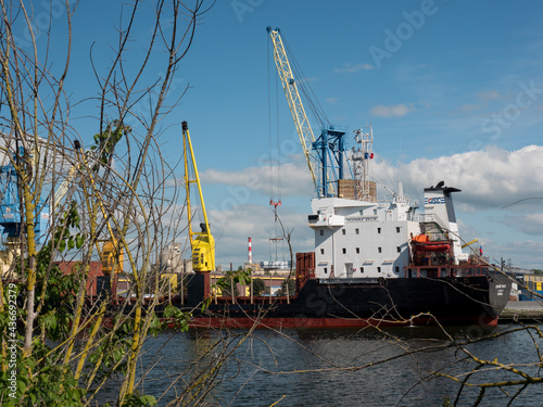 Caen, France May 2021. Unloading of a ship under the Russian flag Mekhanik Brilin, French port of unloading on the Canal de Caen. 4k high definition movie