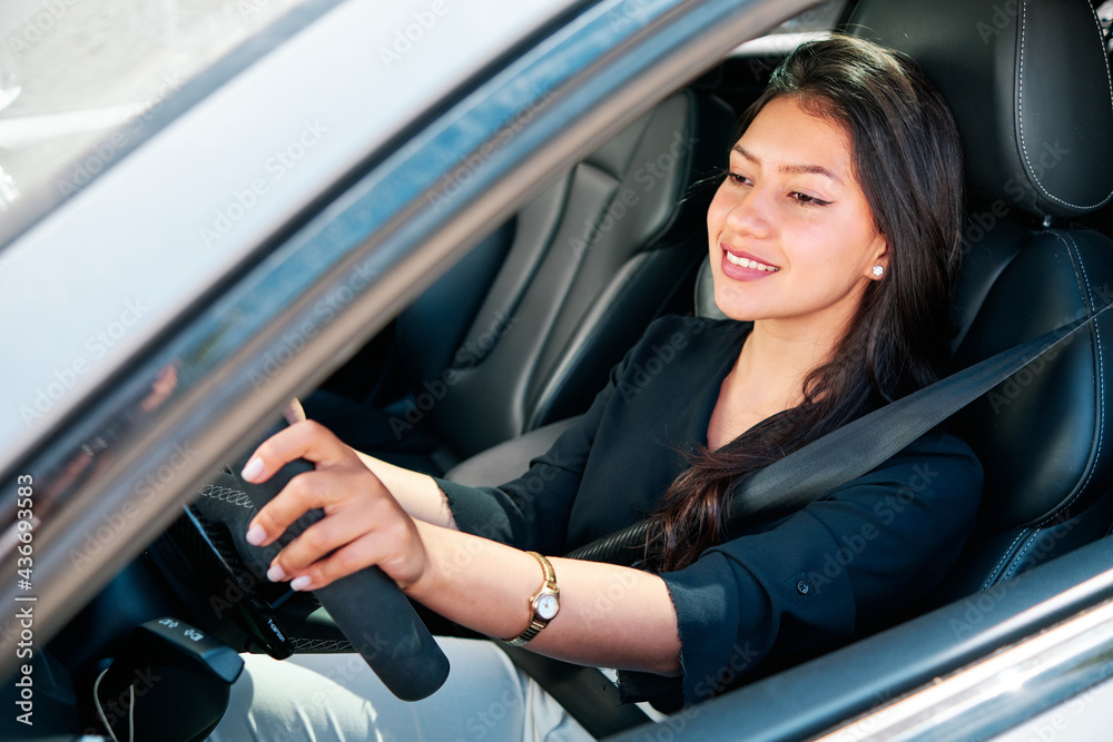 young latin woman driving luxury car young latin woman driving luxury car