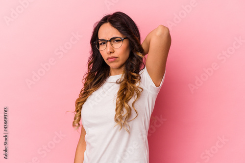 Young mexican woman isolated on pink background suffering neck pain due to sedentary lifestyle.