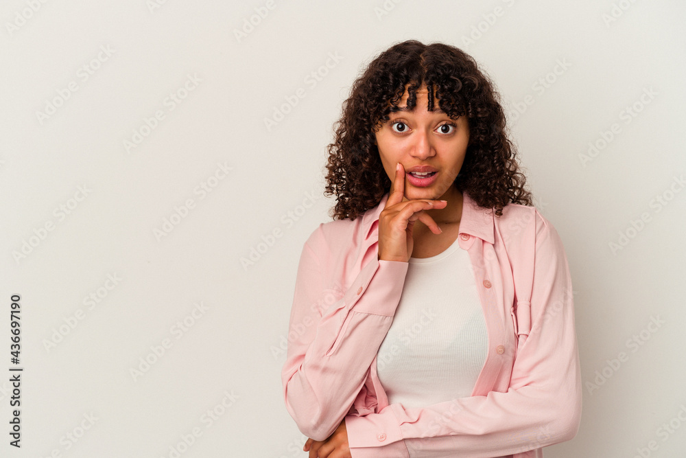 Young mixed race woman isolated on white background looking sideways with doubtful and skeptical expression.