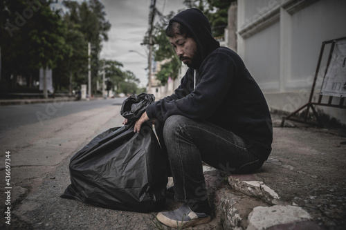 Obraz na plátně Asian man is homeless at the side road,A stranger has to live on the road alone because he has no family