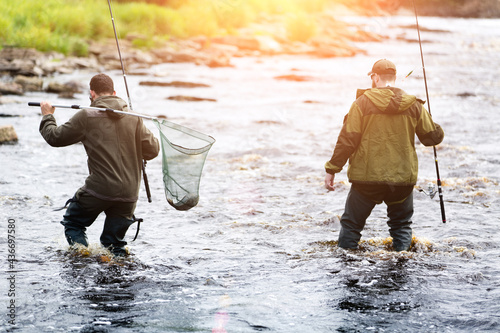 young men fishing on a mountain river