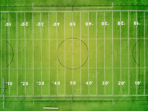An aerial view of a football field showing the yard lines.