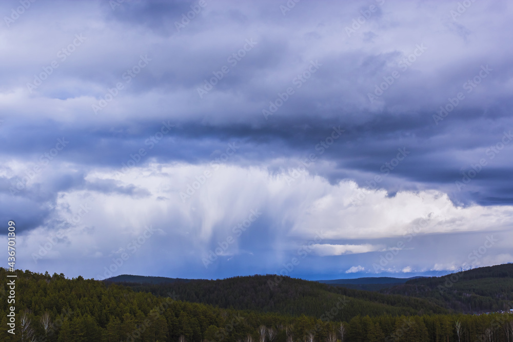 Dramatic thunderstorm clouds background at blue sky Dramatic thunderstorm clouds background at blue sky