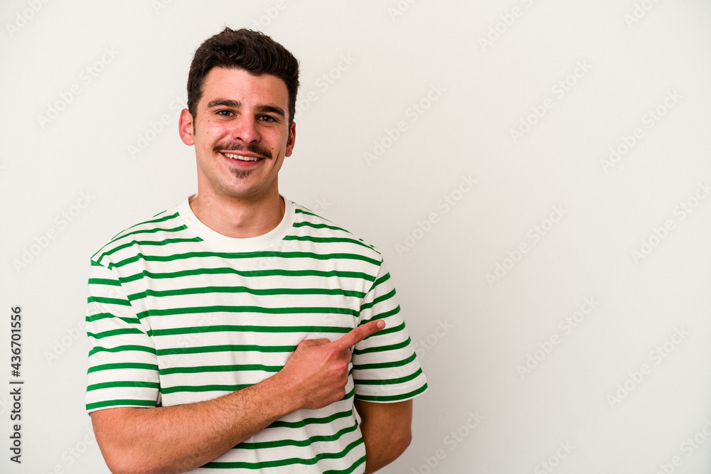 Young caucasian man isolated on white background smiling and pointing aside, showing something at blank space. Young caucasian man isolated on white background smiling and pointing aside, showing something at blank space.