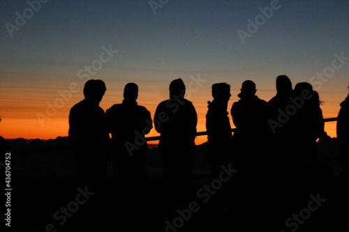 Mount Haleakala Maui, Hawaii, with Cloudy Sunrise with People Enjoying the View with Silhouettes starting a new Day
