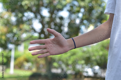 male hands gesture to offer handshaking or offer some help in outdoor view © raypriatna