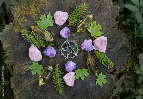 mineral gemstones, pentagram and forest leaves on natural background. Healing quartz stones for Crystal Ritual, Esoteric spiritual practice. modern wicca magic. flat lay photo