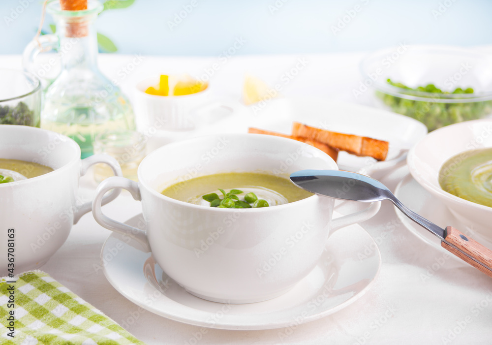 Delicious vegetable soup with potato, broccoli, green pea and spinach on the dinner table Delicious vegetable soup with potato, broccoli, green pea and spinach on the dinner table