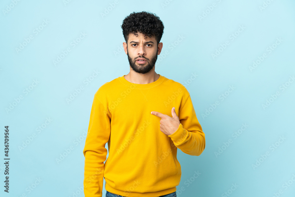 Young Moroccan man isolated on blue background pointing to oneself Young Moroccan man isolated on blue background pointing to oneself