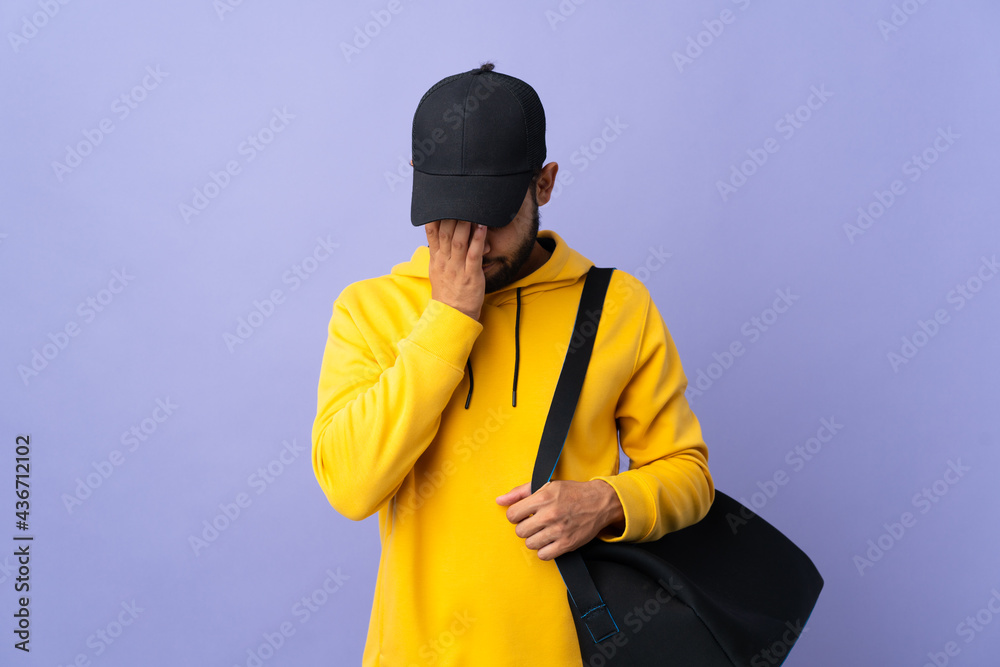 Young sport Moroccan man with sport bag isolated on purple background with tired and sick expression Young sport Moroccan man with sport bag isolated on purple background with tired and sick expression