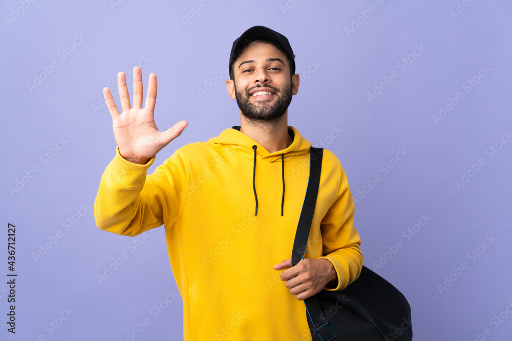 Young sport Moroccan man with sport bag isolated on purple background counting five with fingers Young sport Moroccan man with sport bag isolated on purple background counting five with fingers