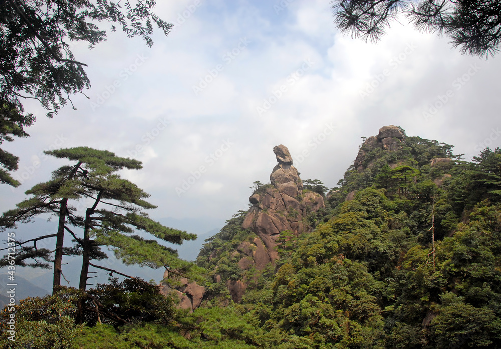 Sanqingshan Mountain in Jiangxi Province, China. View of Goddess Peak, a rocky outcrop on Mount Sanqing representing a woman looking to the distance. Sanqingshan is a Taoist mountain with lush forests