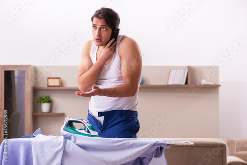 Young male employee ironing in the morning © Elnur