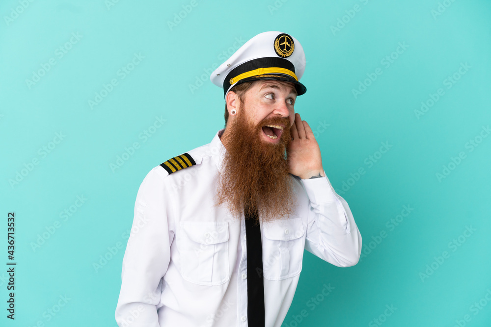 Redhead caucasian man playing rugby isolated on yellow background listening to something by putting hand on the ear Redhead caucasian man playing rugby isolated on yellow background listening to something by putting hand on the ear