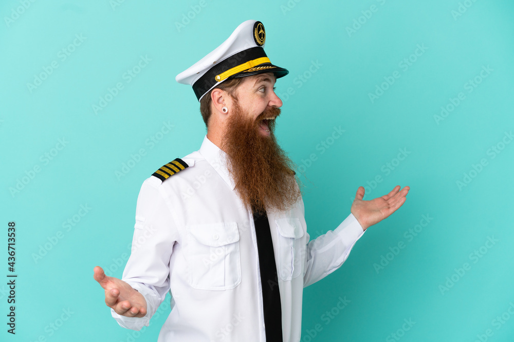 Redhead caucasian man playing rugby isolated on yellow background with surprise expression while looking side
