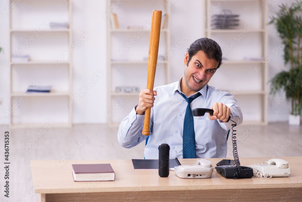 Young male call center operator working at his desk Young male call center operator working at his desk